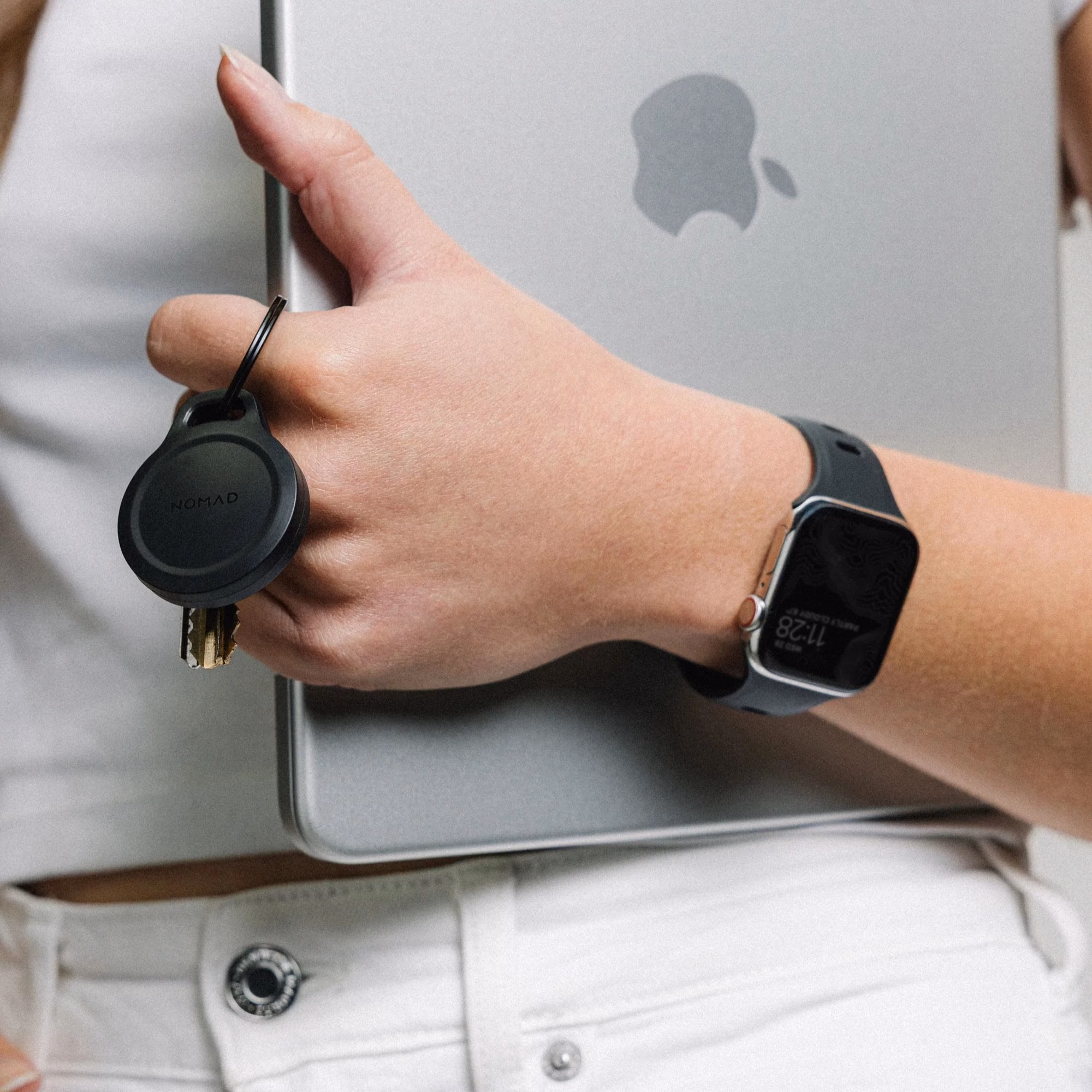 Чохол-брелок Nomad Rugged Keychain поруч з MacBook
